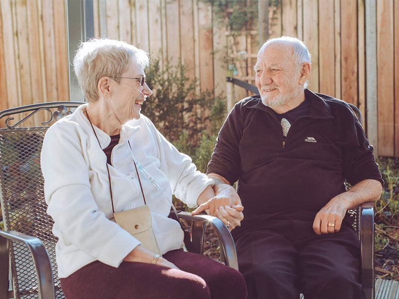 Couple holding hands in garden