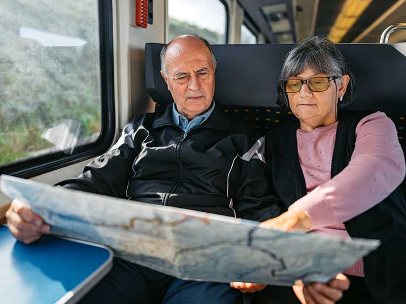 Couple on train looking at map