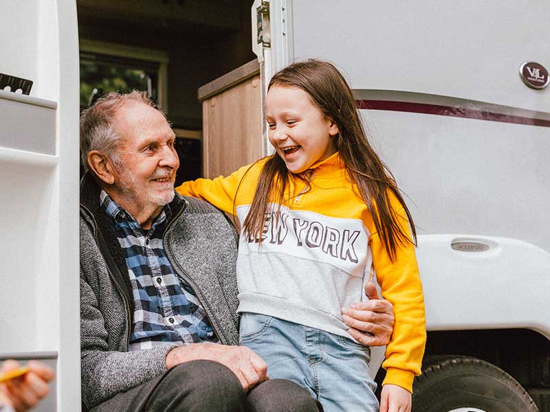 Ian and Dorothy sitting in camper doorwell