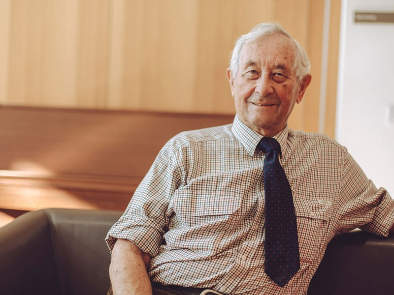 Old man leaning back smiling