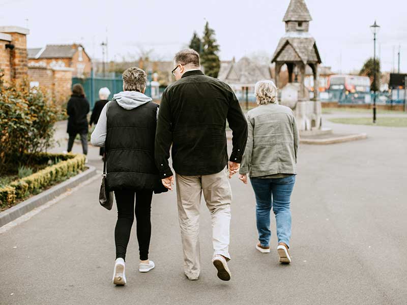 People walking on road in village square